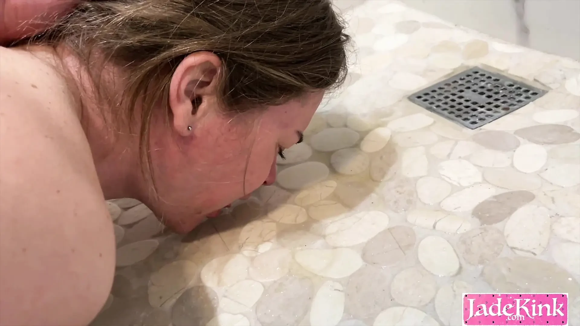 Submissive slut drinking piss from bathroom floor after sex