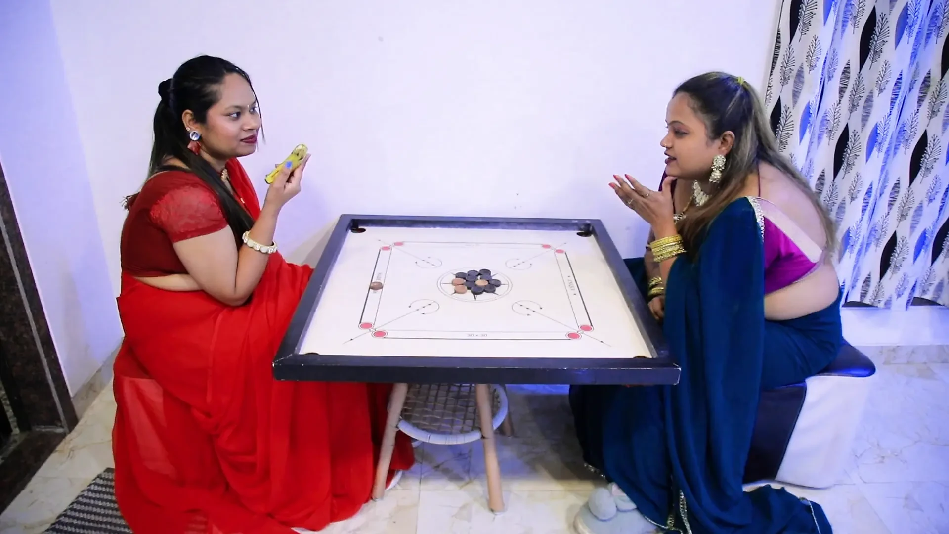 TWO GIRLS BET A BANANA ON THE CARROM GAME