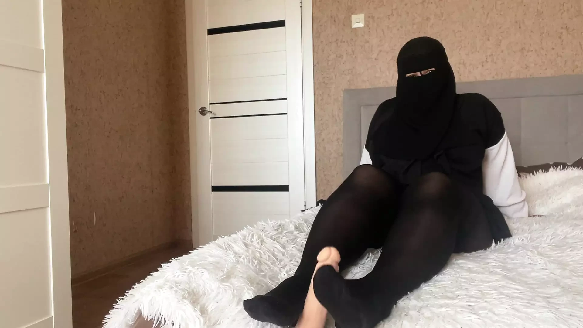 Arab stepmother wearing hijab gives shivering instructions to her husband's son